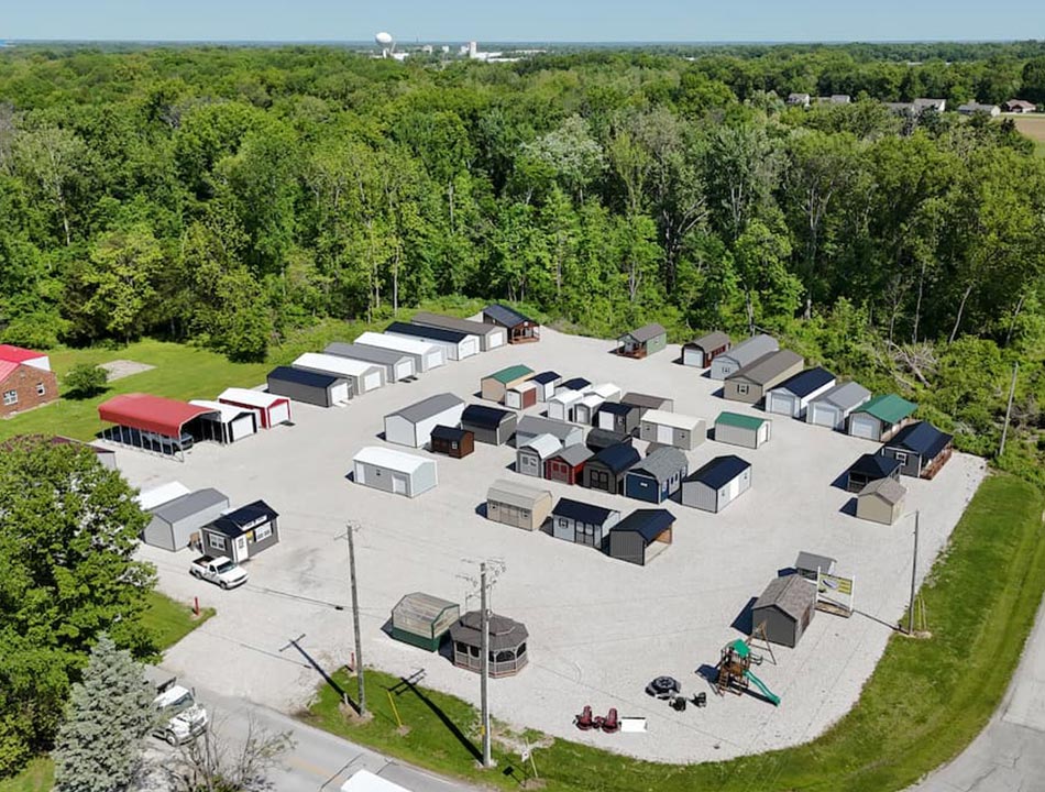 Aerial view of the outdoor display lot at 1878 E Oregon Church Rd filled with storage sheds and structures